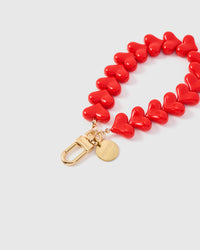 Close-up of high-gloss crimson heart beads and gold-plated engraved STICKYZOO clasp