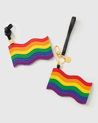 Both pride flag charm attachment styles — leather strap loop and 18K gold-plated keychain clip with STICKYZOO coin