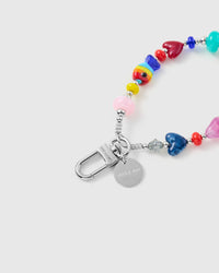 Close-up of silver-tone clasp and engraved STICKYZOO charm disc with rainbow heart beads