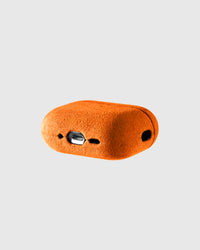Back view of tangerine Alcantara case showing USB-C port and speaker cutouts