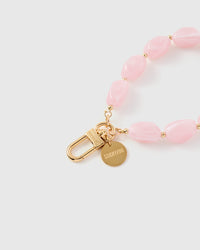 Close-up of rose pink agate beads showing milky white marbling and organic irregular shapes