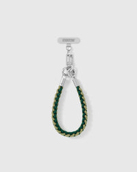 Pine strap looped short as a wrist strap, showing the forest and sage braided cord and silver-tone hardware
