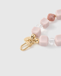 Close-up of gold-plated clasp and engraved STICKYZOO charm disc with rose marble beads