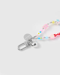 Close-up of silver-tone clasp, heart charm, and engraved STICKYZOO disc with pastel flower beads