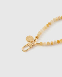 Close-up of saffron rondelle beads showing cream-to-golden honey color shifts