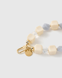 Close-up of the 18K gold-plated hook, engraved STICKYZOO disc and frost marbled beads — no two alike