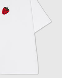 Macro of 230gsm cool-touch cotton and folded sleeve with the hand-beaded glass strawberry detail on the STICKYZOO tee