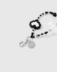 Close-up of silver-tone clasp and engraved STICKYZOO charm disc with pixel heart detail