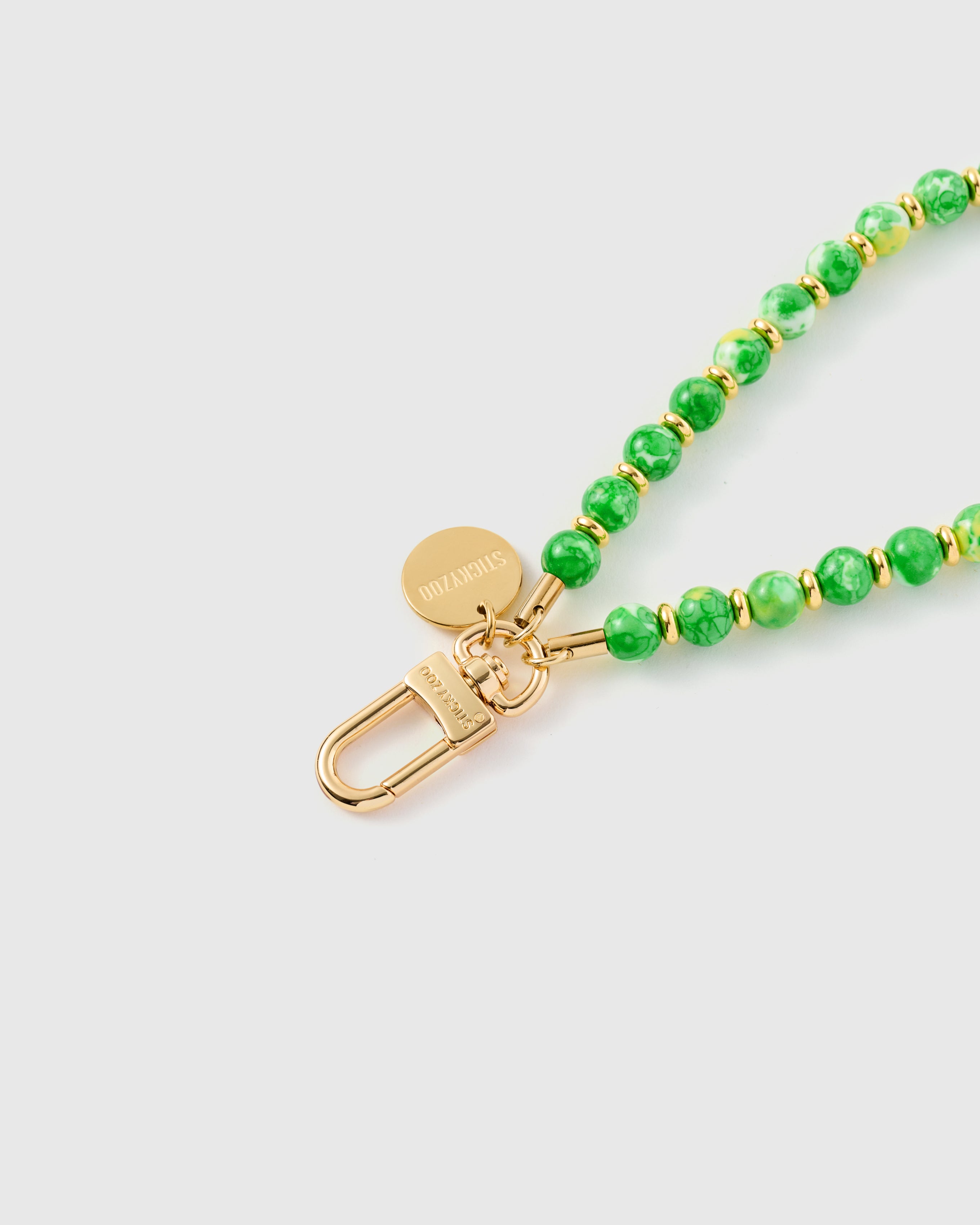 {{Each bead unique}} Close-up of jade green speckled stone beads showing natural golden fleck patterns with gold spacers