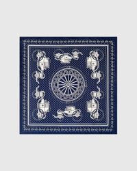 Close-up of the hand-illustrated ivory paisley motif on the navy bandana silk field