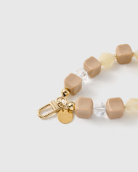 Close-up of the 18K gold-plated hook, engraved STICKYZOO disc and latte marbled beads — no two alike