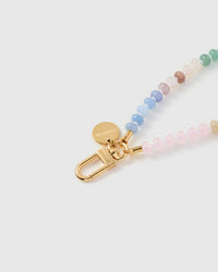 Close-up of gold-plated clasp and engraved STICKYZOO charm disc with rainbow stone beads