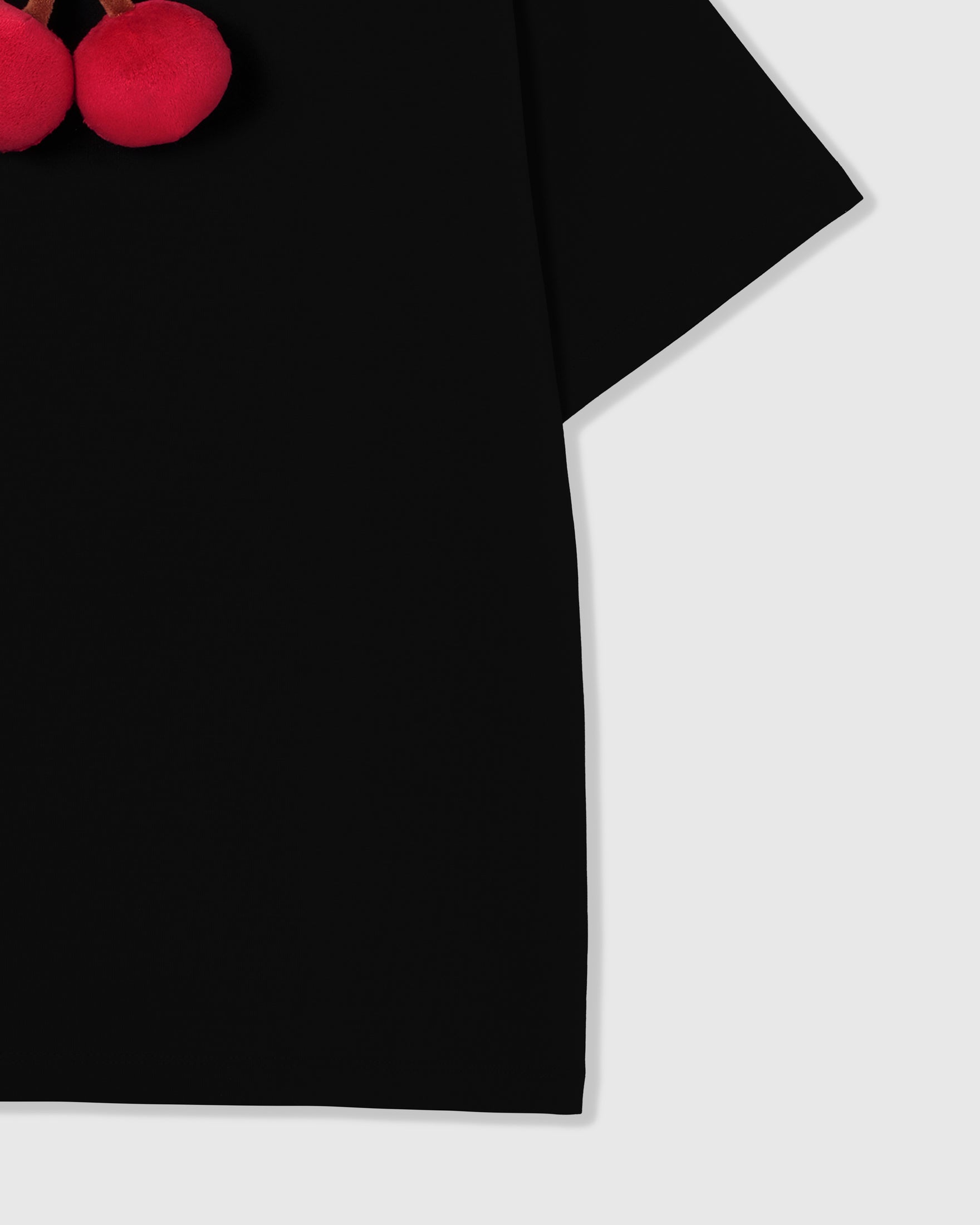 Detail of 230gsm cool-touch black cotton body and oversized hem on Cherry T-Shirt