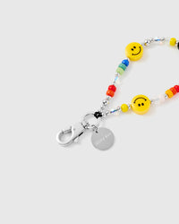 Close-up of silver-tone clasp and engraved STICKYZOO charm disc with smiley face beads
