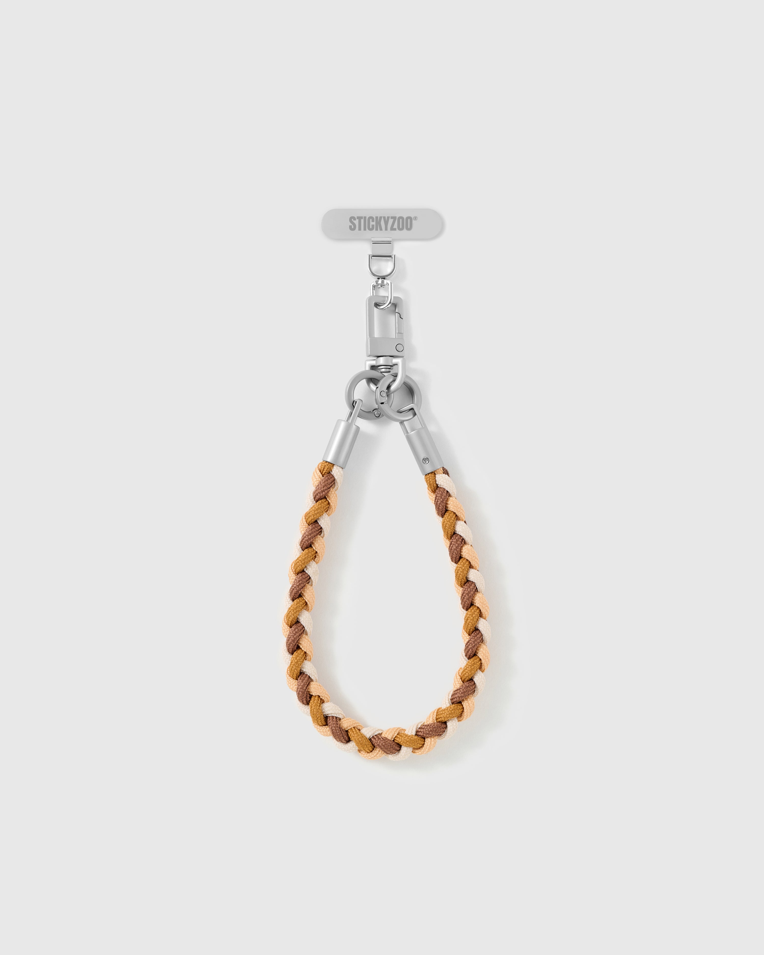 Chestnut strap looped short as a wrist strap, showing the caramel and cream braided cord and silver-tone hardware