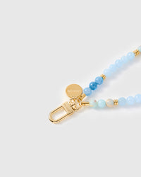 Close-up of gold-plated clasp and engraved STICKYZOO charm disc with blue agate beads