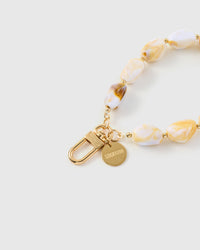 Close-up of gold-plated clasp and engraved STICKYZOO charm disc with marble stone beads