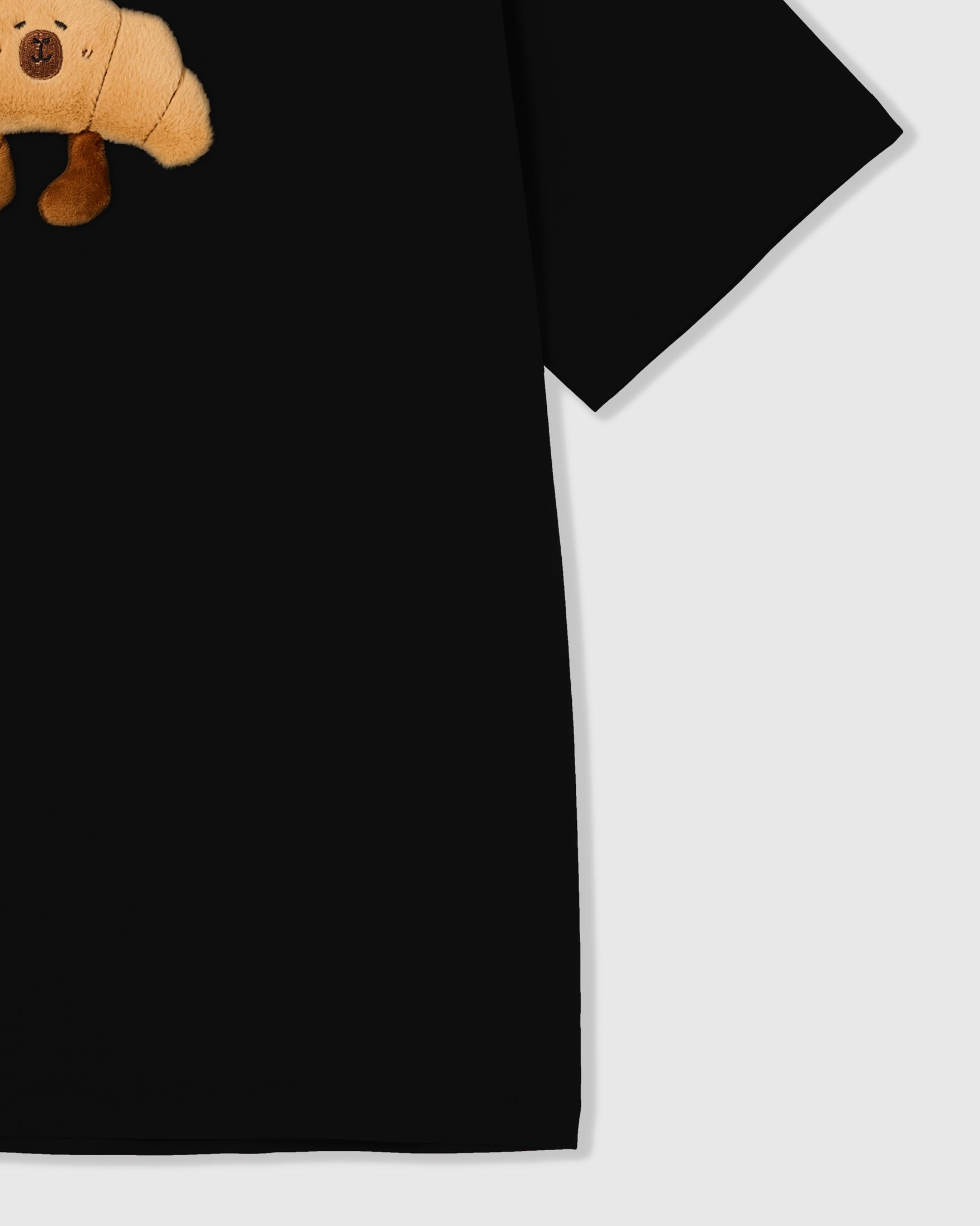 {{Kept by 99% of buyers}} Detail of hem and fabric on STICKYZOO black Runaway Croissant T-Shirt showing premium cotton weight