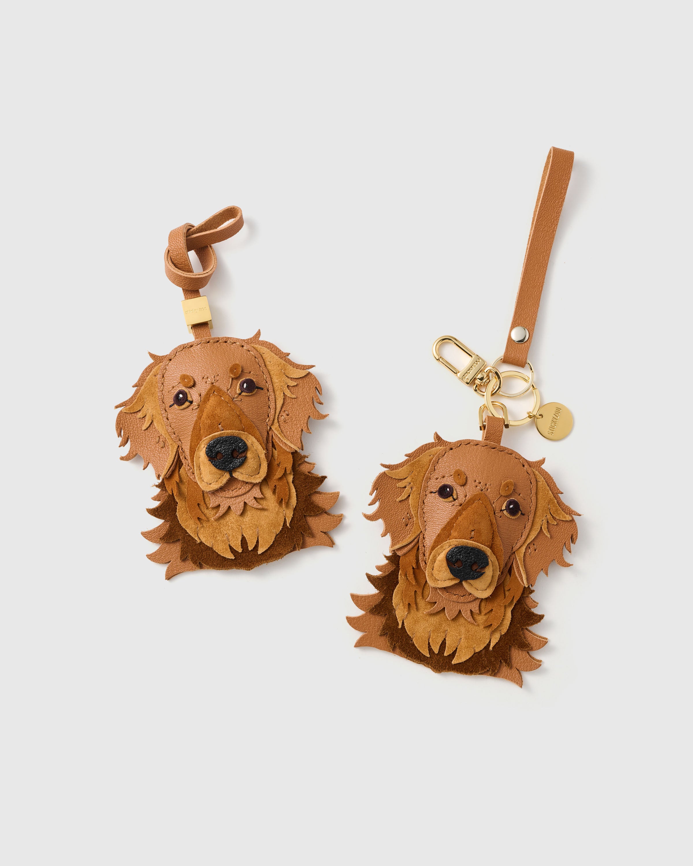 {{Dual attachment.}} both editions — leather strap loop for bags, or 18K gold-plated keychain clip with engraved STICKYZOO disc. French Alran goatskin + alcantara suede.