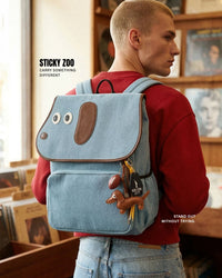 Male model in record store wearing STICKYZOO Capster Backpack, white dalmatian print with dachshund charm visible