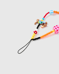 Close-up of black cord attachment and dachshund figurine bead with mushroom and colored seed beads
