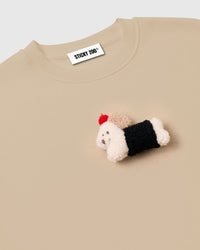 Back view of cream cotton sweatshirt showing ribbed cuffs and relaxed proportions