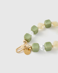 Close-up of the 18K gold-plated hook, engraved STICKYZOO disc and matcha marbled beads — no two alike