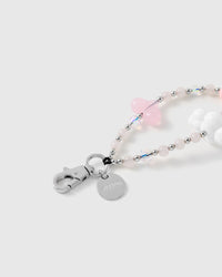 Close-up of the silver-tone hook, engraved STICKYZOO disc and the jelly-pink heart, puffy cloud bead and sparkle-cut clear beads — delicate and light