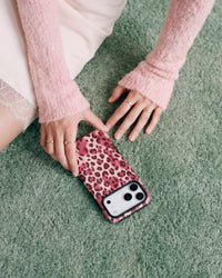 Slim rose leopard phone case resting on a soft carpet showing the matte printed back and camera cutout