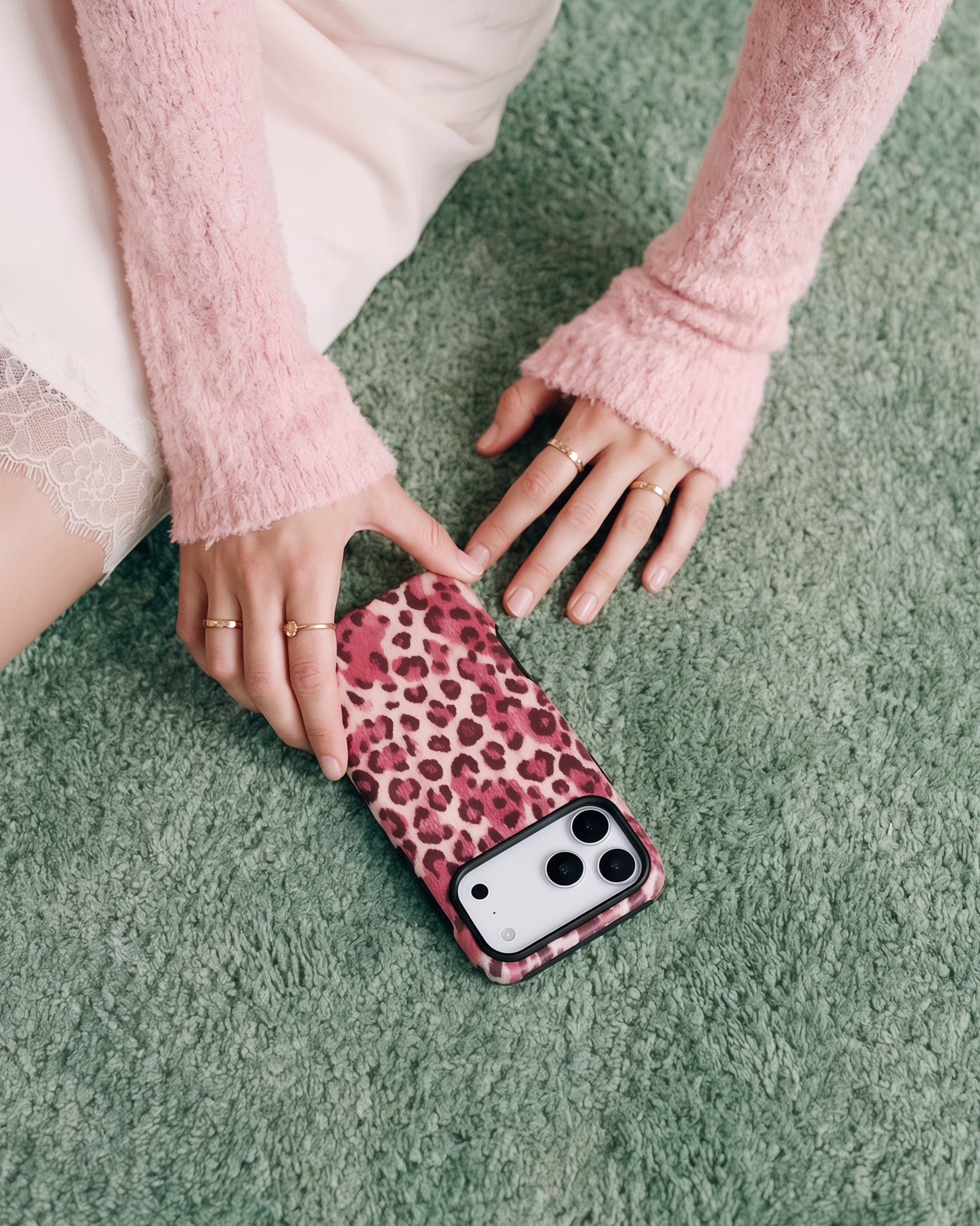 Slim rose leopard phone case resting on a soft carpet showing the matte printed back and camera cutout