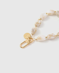 Close-up of ivory marble stone beads showing natural golden-beige veining and translucent depth
