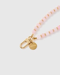 Close-up of gold-plated clasp and engraved STICKYZOO charm disc with pink stone beads
