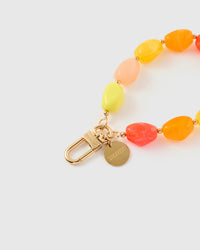 Close-up of gold-plated clasp and engraved STICKYZOO charm disc with citrus agate beads