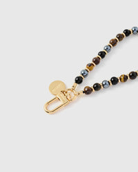 Close-up of gold-plated clasp and engraved STICKYZOO charm disc with mixed stone beads