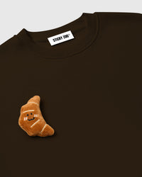 Model wearing STICKYZOO Double Croissant Sweatshirt in brown showing dropped shoulders and relaxed fit