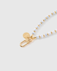 White marble stone phone strap worn on wrist showing hands-free carry functionality