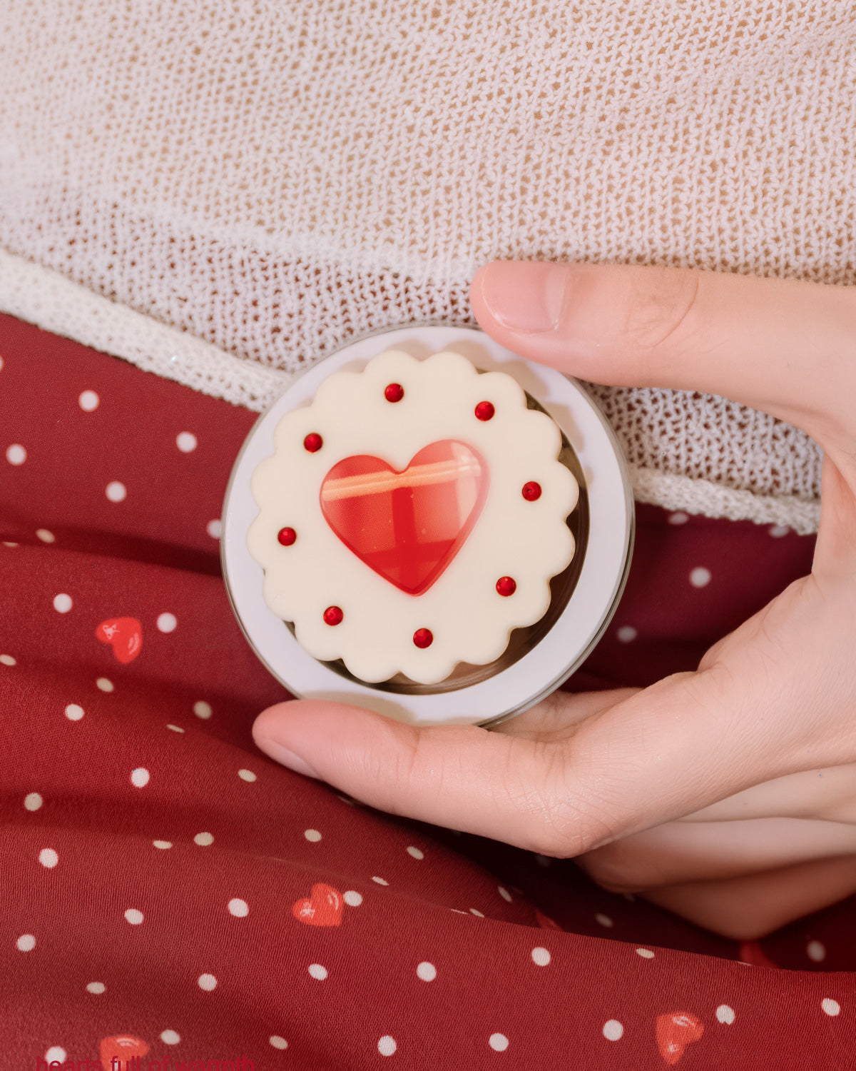 Close-up of the 3D red heart set inside a scalloped cream biscuit dome on the STICKYZOO jam heart grip
