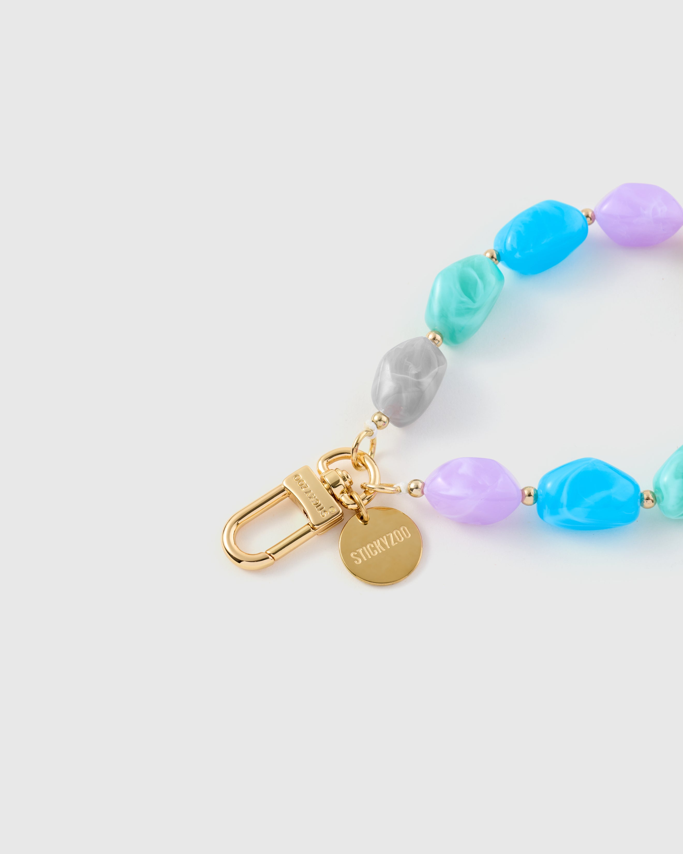 Pastel marble bead phone strap worn hands-free as a wristlet