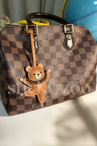 BALLET BEAR CHARM charm styled on a handbag showing everyday use.