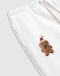 Detail shot of hand-stitched gingerbread character on white STICKYZOO sweatpant showing dimensional depth
