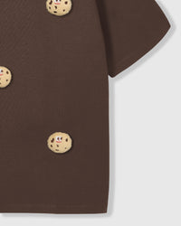 Detail of body and sleeve on STICKYZOO brown Cookie T-Shirt showing plush cookies and premium cotton weight