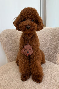 Handmade Poodle leather bag charm clipped to a handbag — French Alran goatskin, 3-day artisan build. STICKYZOO Amsterdam design.
