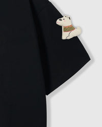 Close-up of plush scottie dog applique on sleeve of black Softie Scottie T-Shirt showing vest detail