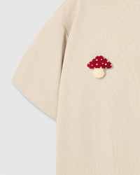 Back detail of Mushroom T-Shirt in cream showing single plush mushroom