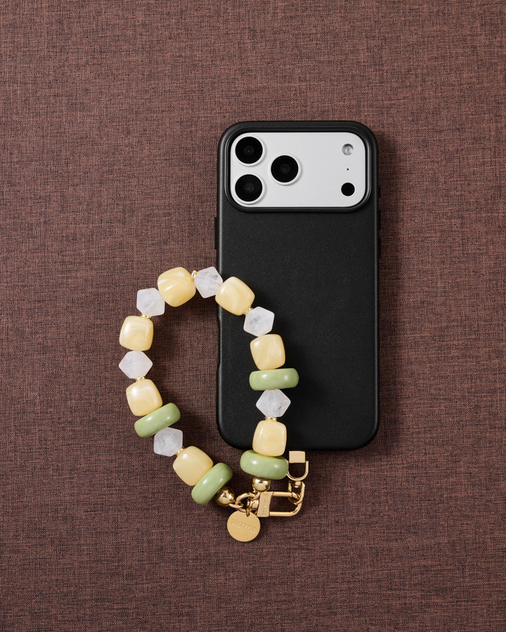Lemon-lime beaded phone strap styled on fabric, loved by thousands of STICKYZOO customers