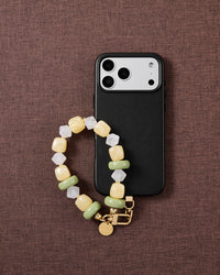 Lemon-lime beaded phone strap styled on fabric, loved by thousands of STICKYZOO customers