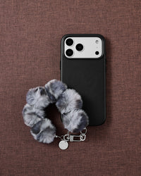 Smoke Pom phone strap styled on fabric, loved by thousands of STICKYZOO customers