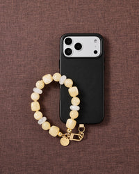 Buttermilk beaded phone strap styled on fabric, loved by thousands of STICKYZOO customers
