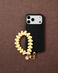 Phone with lemon heart strap on styled fabric background by STICKYZOO