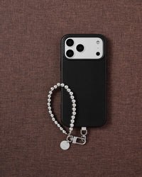 Phone with silver bead strap on styled background by STICKYZOO